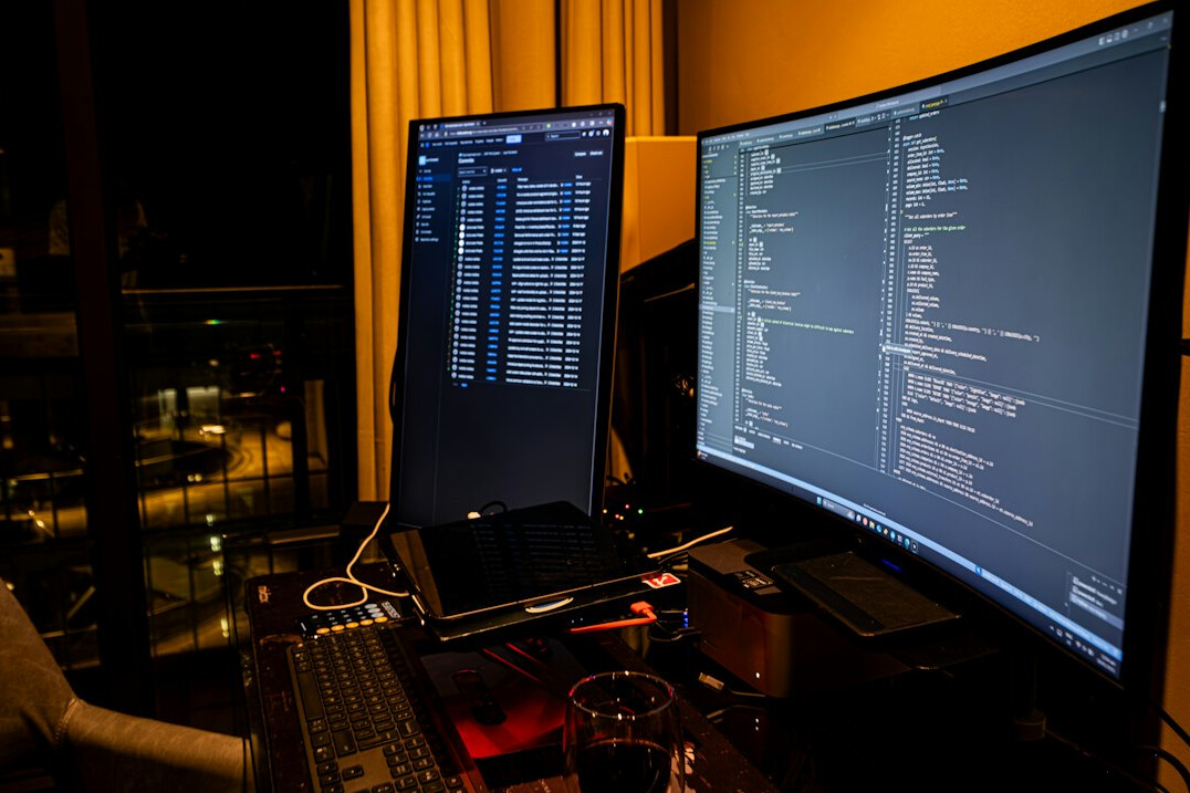 Code on a laptop screen in a dim room