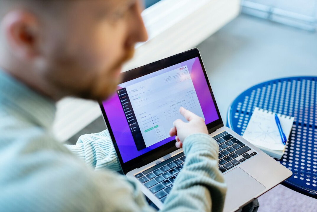 young programmer coding on laptop
